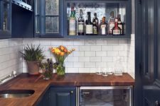 19 a small dark blue kitchen with a saturated wooden countertop looks chic