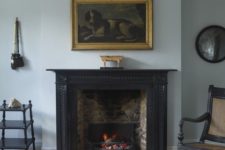 19 a vintage black fireplace, which is actually used for keeping the room warm and cozy
