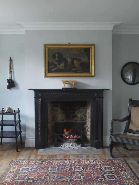 a vintage black fireplace, which is actually used for keeping the room warm and cozy