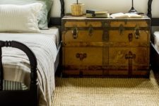 20 a lrge vintage trunk as a shared nightstand for a guest bedroom