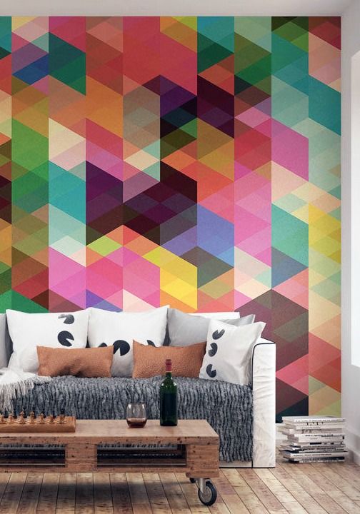 an industrial living room with a colorful geo statement wall