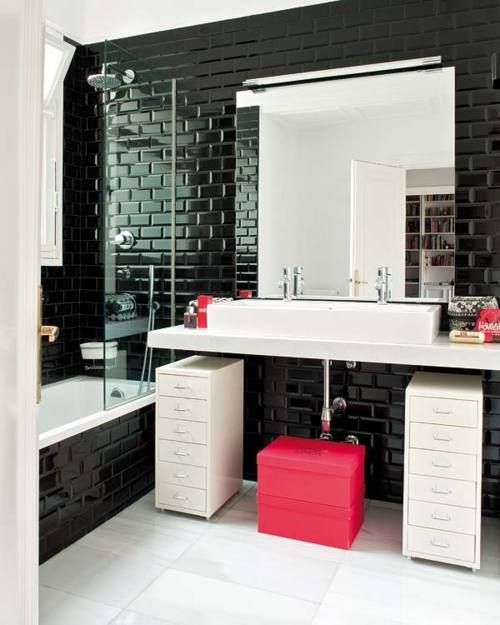 Glossy black tiles with black grout for an eye catchy monochrome space with pink accents