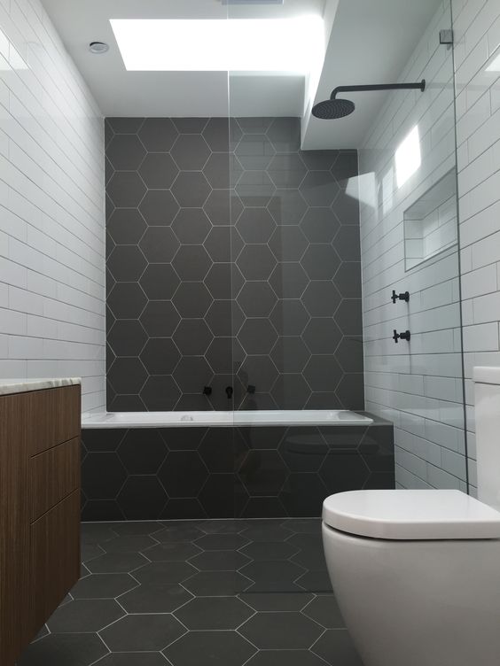 Matte graphite grey hexagon tiles and white subway ones create an interesting and eye catchy space