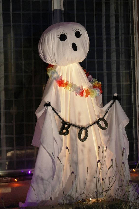a ghost of a white sheet, with a letter banner and a bold fabric necklace