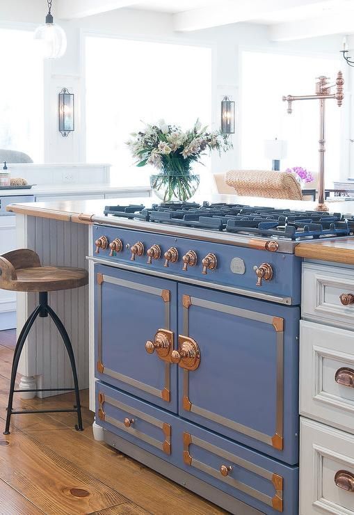 a retro French stove in blue with copper touches makes a gorgeous statement