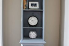 22 a grandfather’s clock was repainted and repurposed into a shelf with drawers