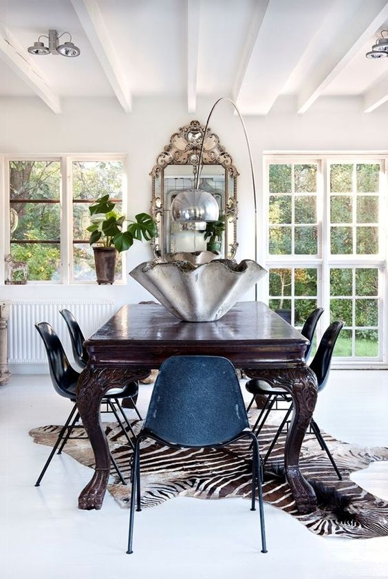 a large zebra print rug to spruce up a vintage dining space