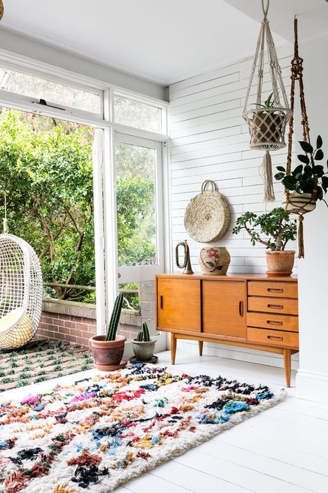 a boho space spruced up with a colorful textural rug