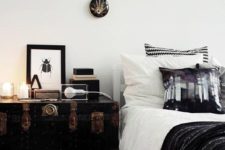 23 a vintage black trunk with copper detailing serves as a nightstand and a storage piece and it looks amazing
