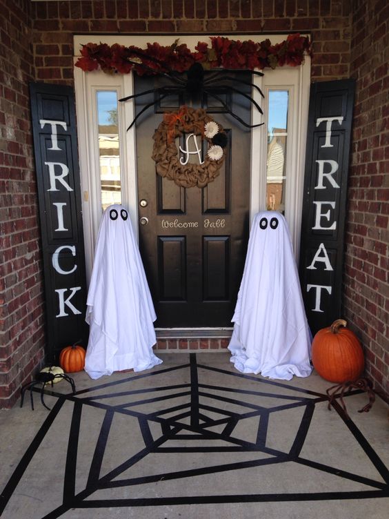 ghosts of white sheets are placed on both sides of the entrance