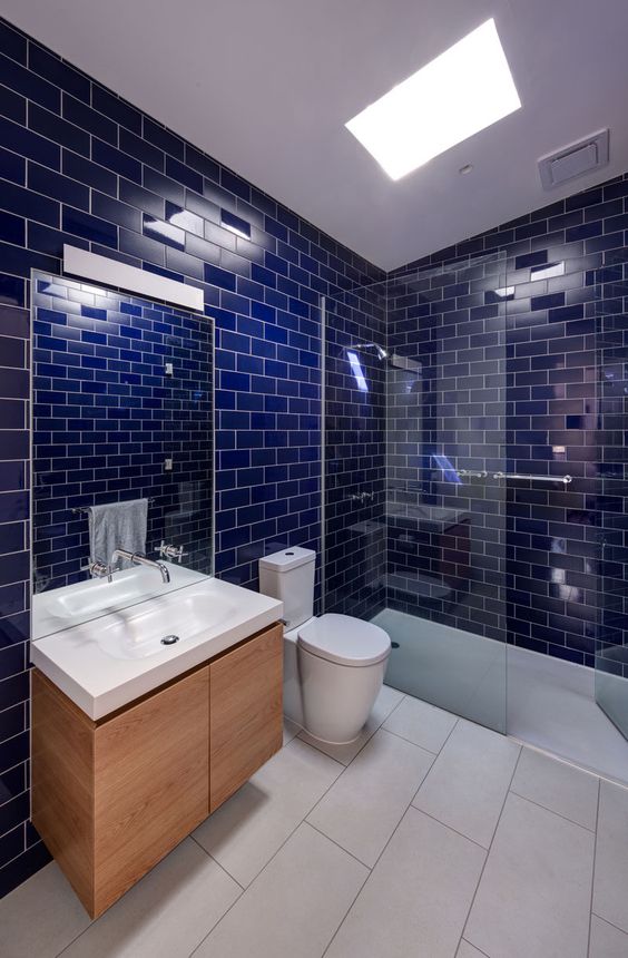 glossy cobalt blue tiles with white grout are a great choice for a modern bathroom with a color statement