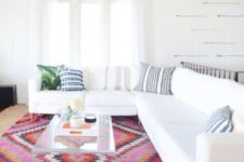 24 a white living room with a colorful patterned ethnical-inspired rug
