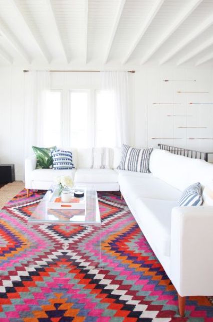 a white living room with a colorful patterned ethnical-inspired rug
