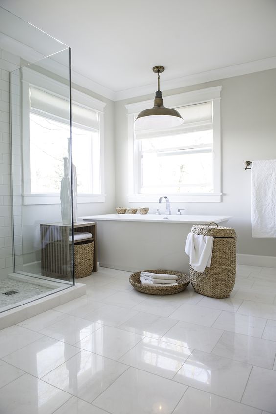 Glossy large scale tiles on the floor make the peaceful bathroom more eye catchy
