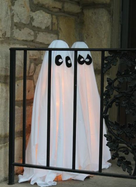 make some ghosts of white sheets and add eyes of black fabric, then lit them up from the inside