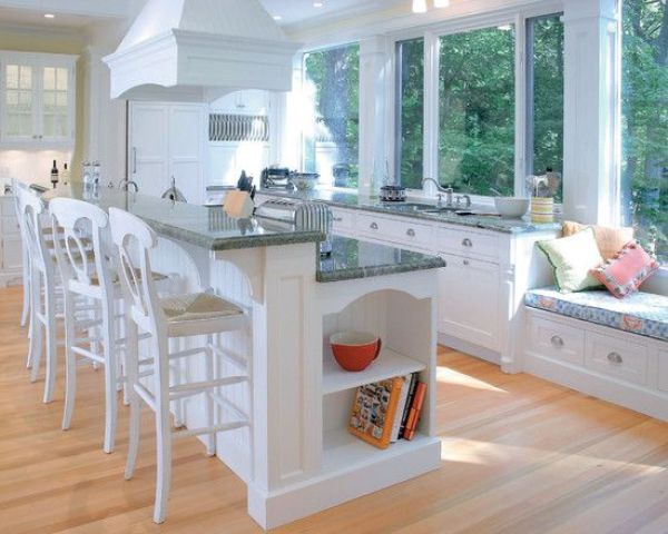a two-level kitchen island with two level for cooking and eating perfectly fits a traditional kitchen