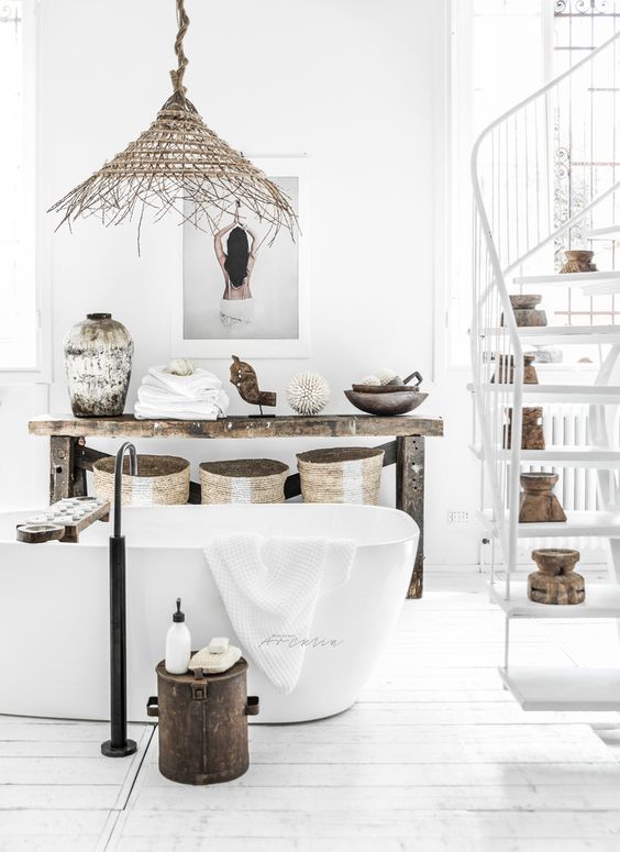 wicket baskets, a wicker lamp, shabby vases and natural wood touches add to the white space