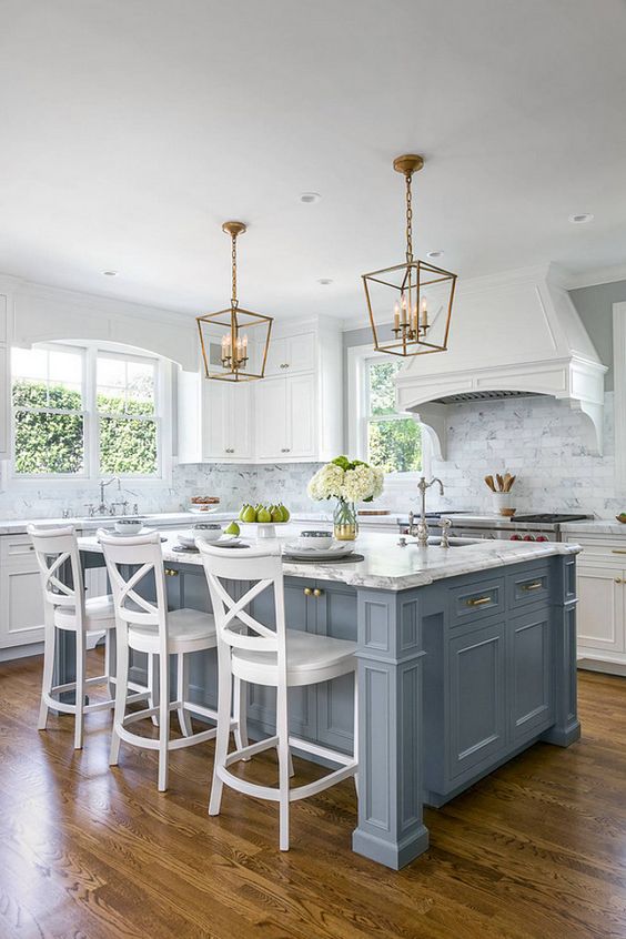 a vintage kitchen is given a coastal touch with a pale blue kitchen island