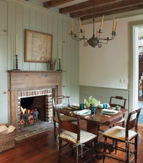 an antique fireplace clad with brick and wood and is used for creating a comfy ambience
