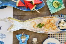 26 fish-shaped and painted dishes and plates are perfect for a Mediterranean dining space