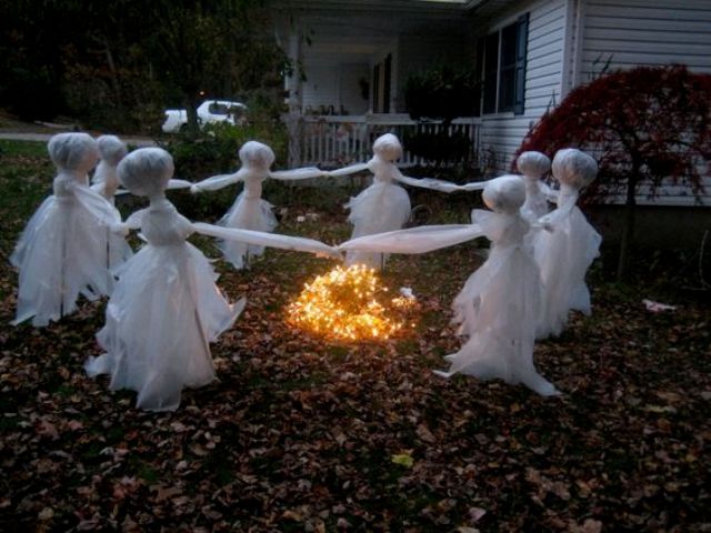 scary children ghosts dancing around the fire are made of white tulle and wire