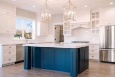 27 a white vintage kitchen with a cobalt blue kitchen island and a white countertop