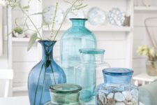 27 aqua, blue and turquoise glass bottles with shells and herbs for a Mediterranean arrangement