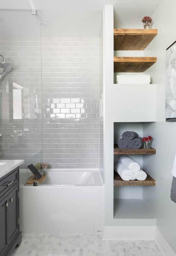 glossy white subway tiles with white grout make the bathtub zone look more interesting and glossy