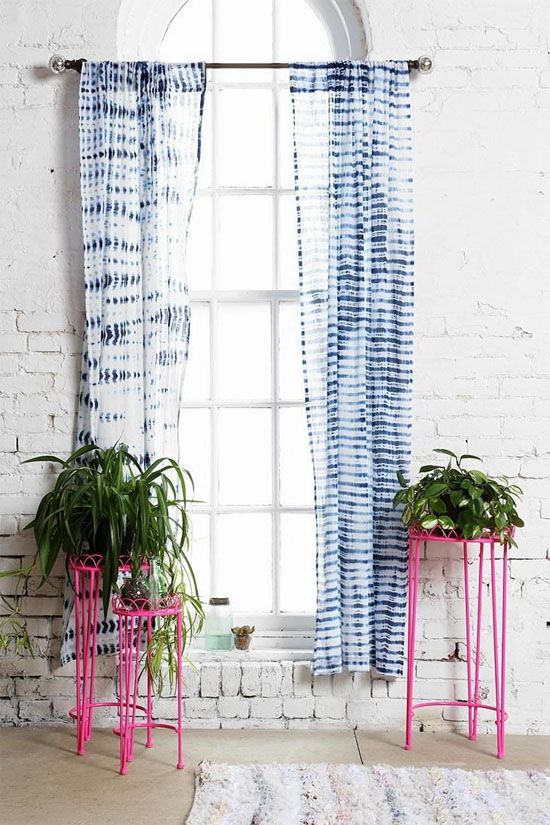 shibori curtains stand out in front of whitewashed brick walls