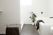 27 small white square tiles and matte black hex ones create a chic Scandinavian-inspired space
