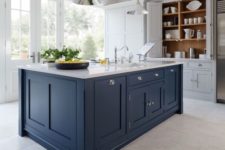 28 a white kitchen with a dark blue kitchen island and a white countertop