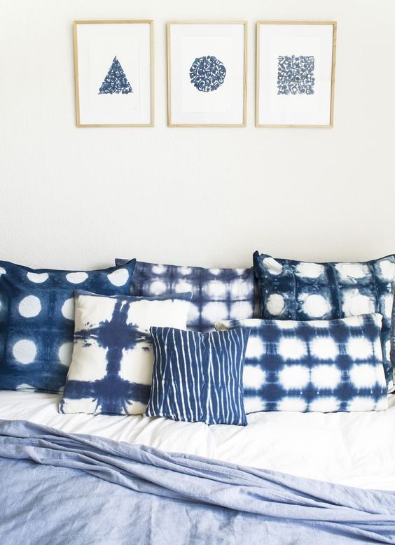 shibori dyed pillows and matching wall arts on the wall will make your bedroom heavenly