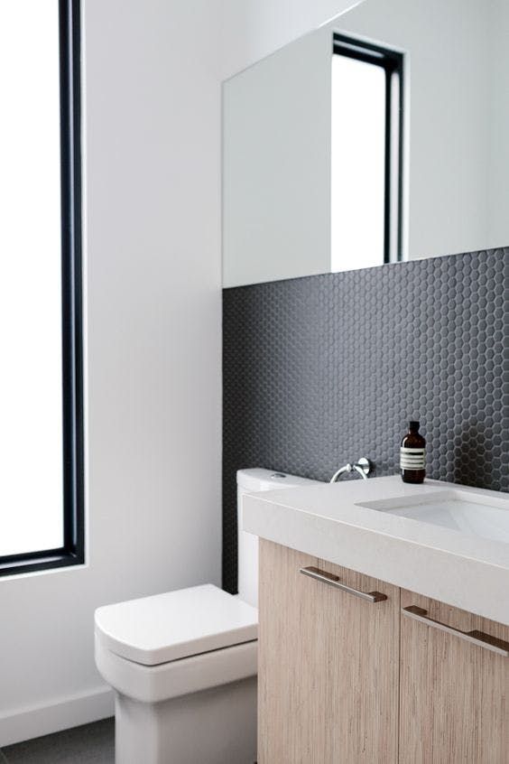 tiny matte black hex tiles to make a minimalist bathroom eye-catching