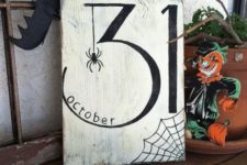 29 a stylish black and white Halloween sign with a spider, a web, and the date
