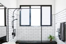 30 white subway tiles with black grout and matte black tiles with white grout make up an eye-catchy space