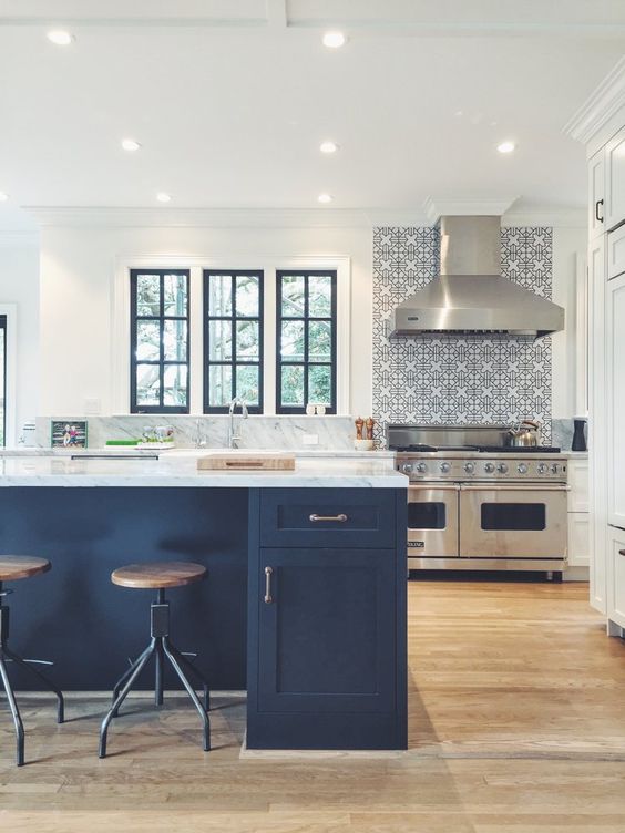 a neutral kitchen is made more chic with a navy kitchen island and window frames