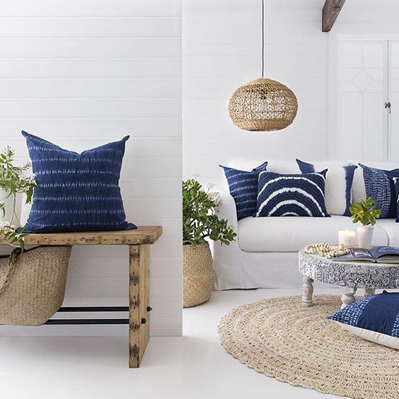white seaside spaces are made chic with shibori pillows and wicker accents