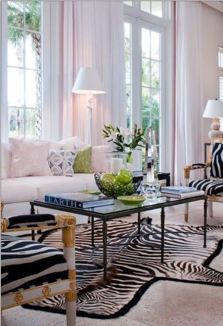 exquisite zebra upholstery chairs and a zebra print rug for a glam space