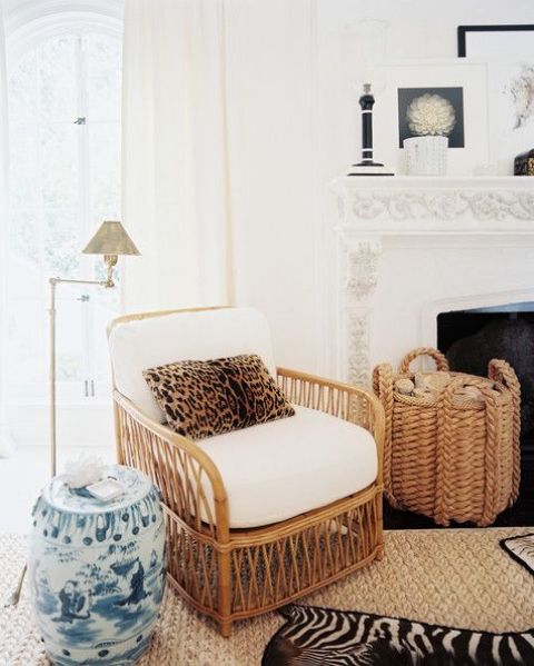 a cozy rustic living room with wicker furniture and a cheetah print pillow for an eye-catchy accent