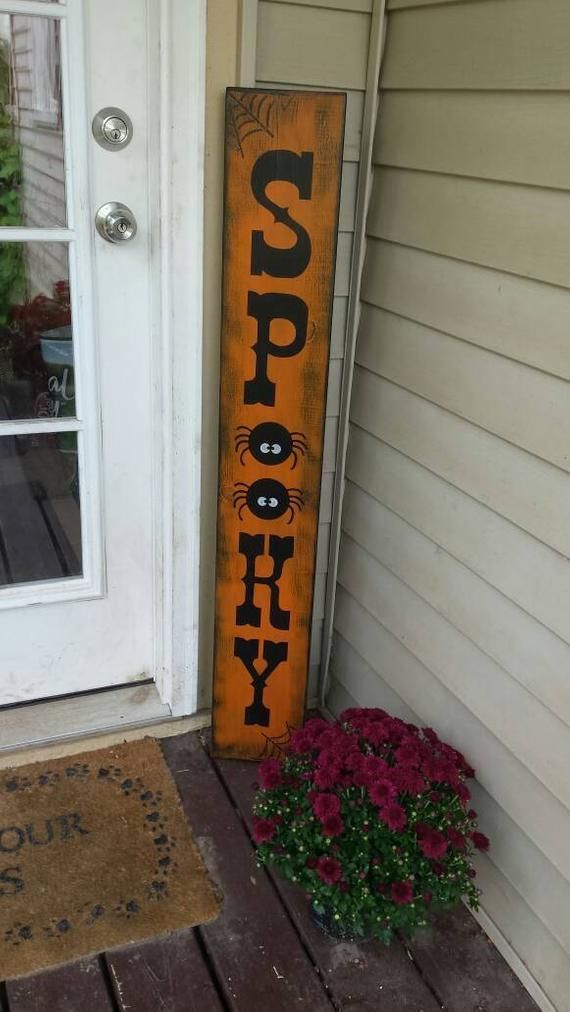 an oversized spooky sign made of distressed wood is right what you need for a front porch