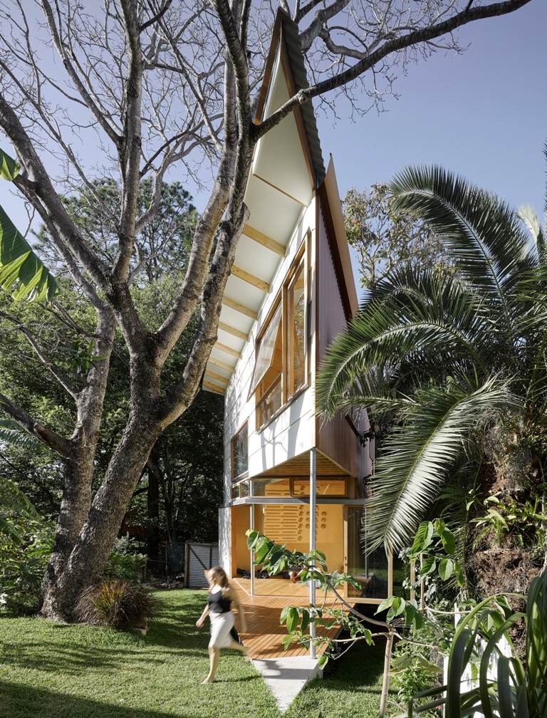 This garden house was built in treehouse style and it features a pointed design with several spaces inside