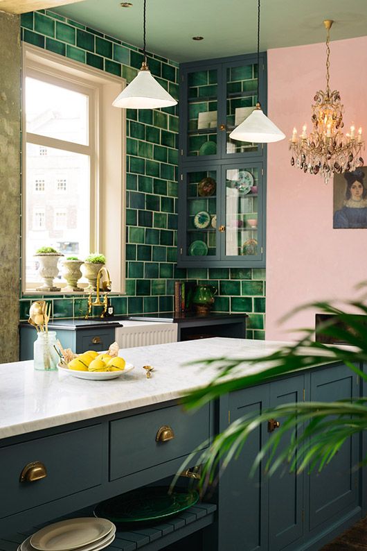 a green tile wall looks nice with grey cabinets and adds a cool bright touch to the kitchen