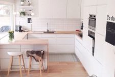 03 a small U-shaped kitchen done in white with a breakfast space and cooking zone in one