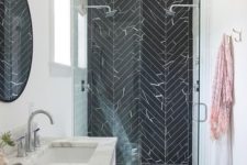 03 stainless steel is dominating in this modern bathroom but there are also brass touches