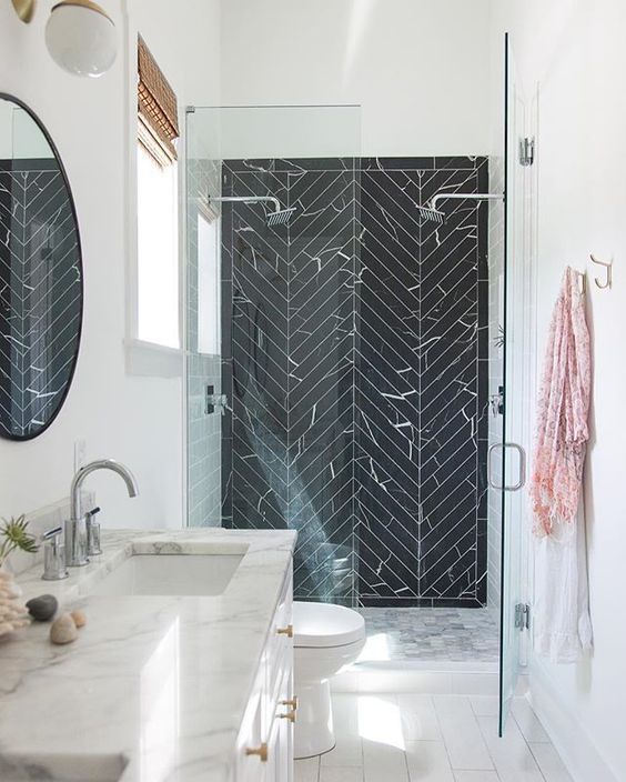 stainless steel is dominating in this modern bathroom but there are also brass touches