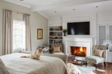 04 a whitewashed brick fireplace brings extreme coziness to the bedroom