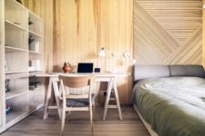 bedroom with a workspace that is clad in wood