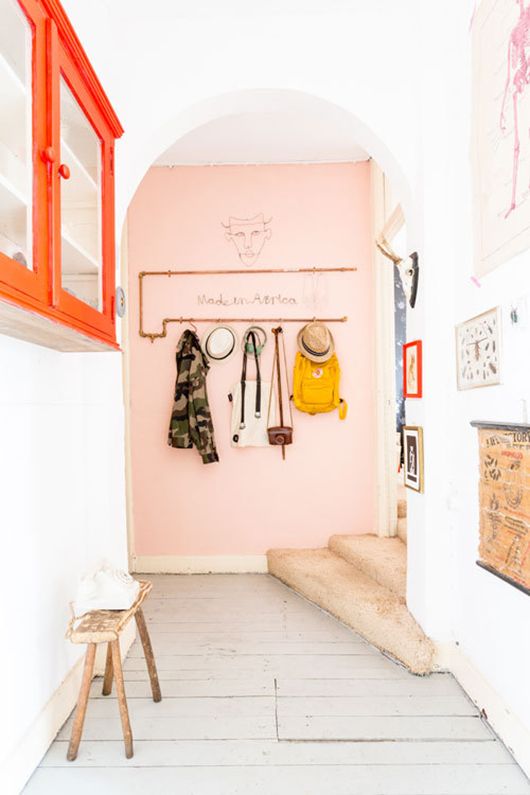 a pop of pink here creates a soft and sweet look in this entryway