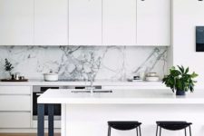 05 a white kitchen with a white marble backsplash and metal details for a cool look
