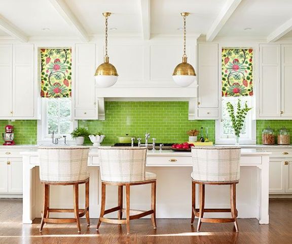 a neutral kitchen is spurced up with colorful roman shades and a bold green tile backsplash